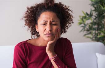 Woman with a dental emergency in Houston