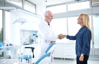 Emergency dentist in Houston shaking hands with a patient