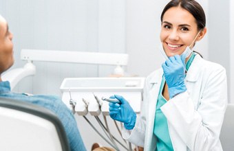 Dentist smiling at patient's dental exam