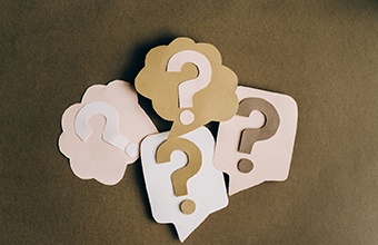 Paper question marks for dental implant FAQs