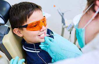 Young boy in dental chair receives sealants