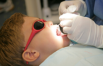 Young boy receiving topical fluoride treatment