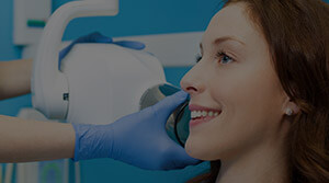 Woman in dental chair receiving x-rays