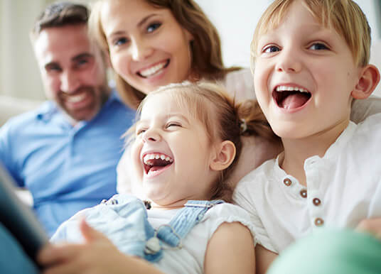 Happy family laughing on a couch