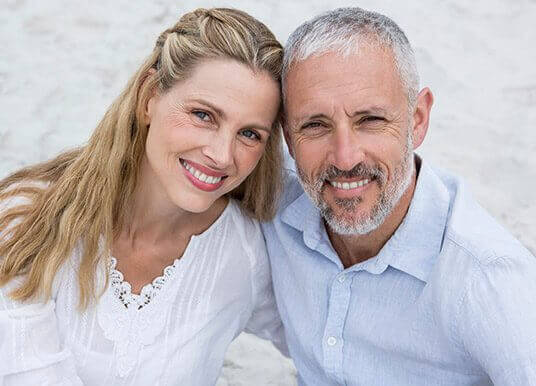 Older couple with happy healthy smiles