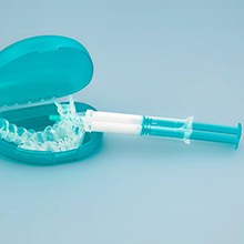 A take-home whitening kit on a blue background
