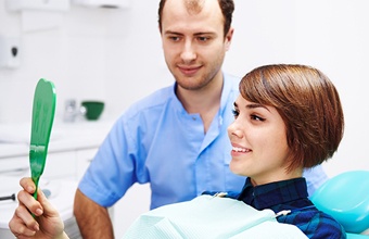 Woman looking at her smile in mirror