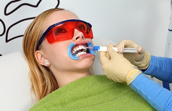 Woman receiving teeth whitening