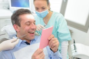 man smiling looking in mirror