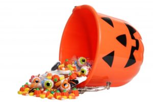 A bucket of candy spilling onto the floor.