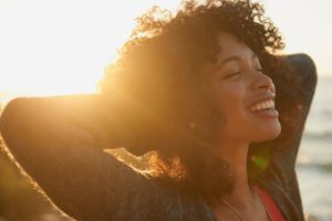 woman relaxing outside to prevent gum disease